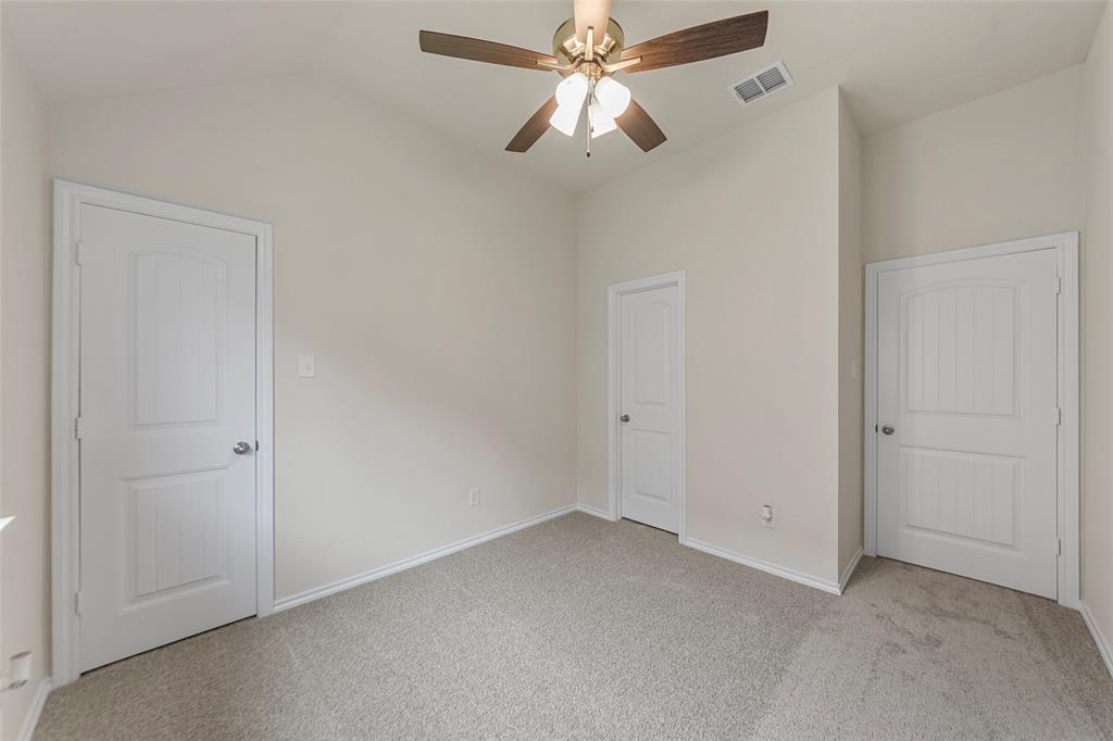 425 Tobin Drive Seagoville, TX 75159 - Photo 13 of 20 Unfurnished bedroom with vaulted ceiling, carpet flooring, baseboards, and a ceiling fan