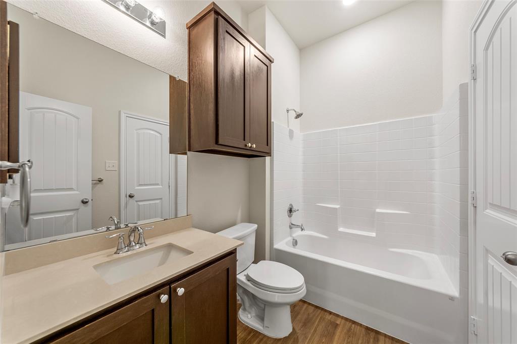 425 Tobin Drive Seagoville, TX 75159 - Photo 14 of 20 Bathroom featuring wood finished floors, toilet, vanity, and shower / tub combination