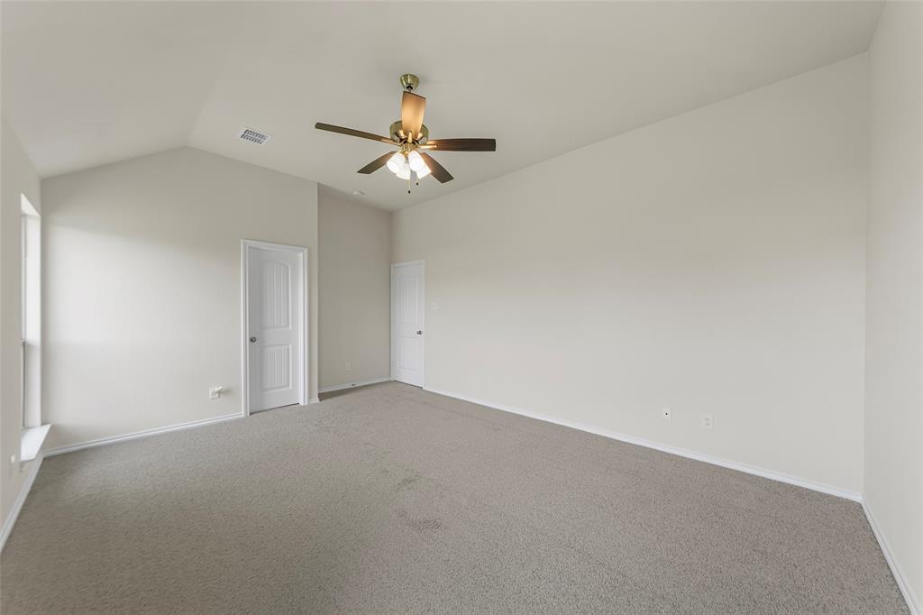 425 Tobin Drive Seagoville, TX 75159 - Photo 17 of 20 Carpeted empty room with lofted ceiling, a ceiling fan, and baseboards