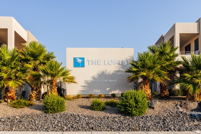 1122 South 1790th West, Unit 1 St. George, UT 84770 - Photo 31 of 37 Contemporary architecture featuring a central sign for "THE LOFTS," flanked by mature palm trees