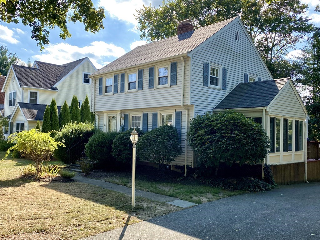 10 Duxbury Road Wellesley, MA 02481 - Photo 1 of 15 a front view of a house with garden