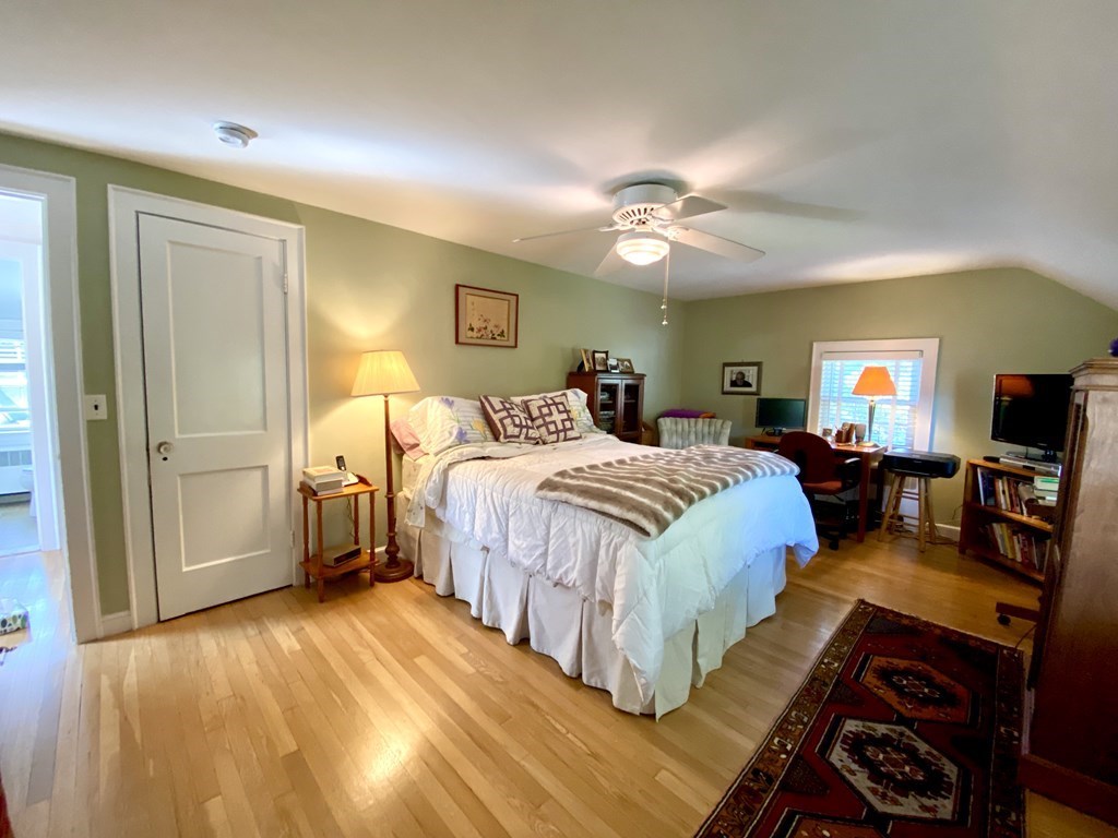 10 Duxbury Road Wellesley, MA 02481 - Photo 8 of 15 a spacious bedroom with a bed a chandelier and a dresser