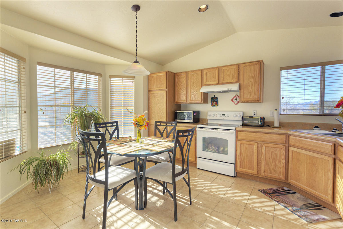 1778 Guess Court Rio Rico, AZ 85648 - Photo 2 of 19 a kitchen with a stove a table and chairs in it