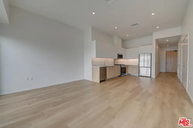 a view of kitchen with furniture and refrigerator
