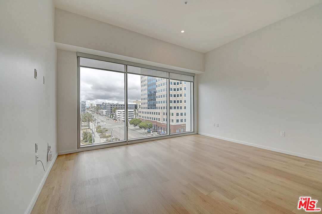 200 West Ocean Boulevard, Unit 711 Long Beach, CA 90802 - Photo 12 of 21 a view of an empty room with wooden floor and a window