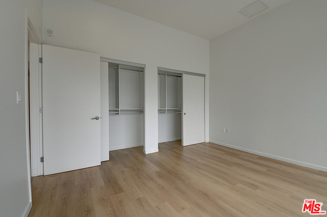 200 West Ocean Boulevard, Unit 711 Long Beach, CA 90802 - Photo 14 of 21 a view of an empty room with wooden floor and closet