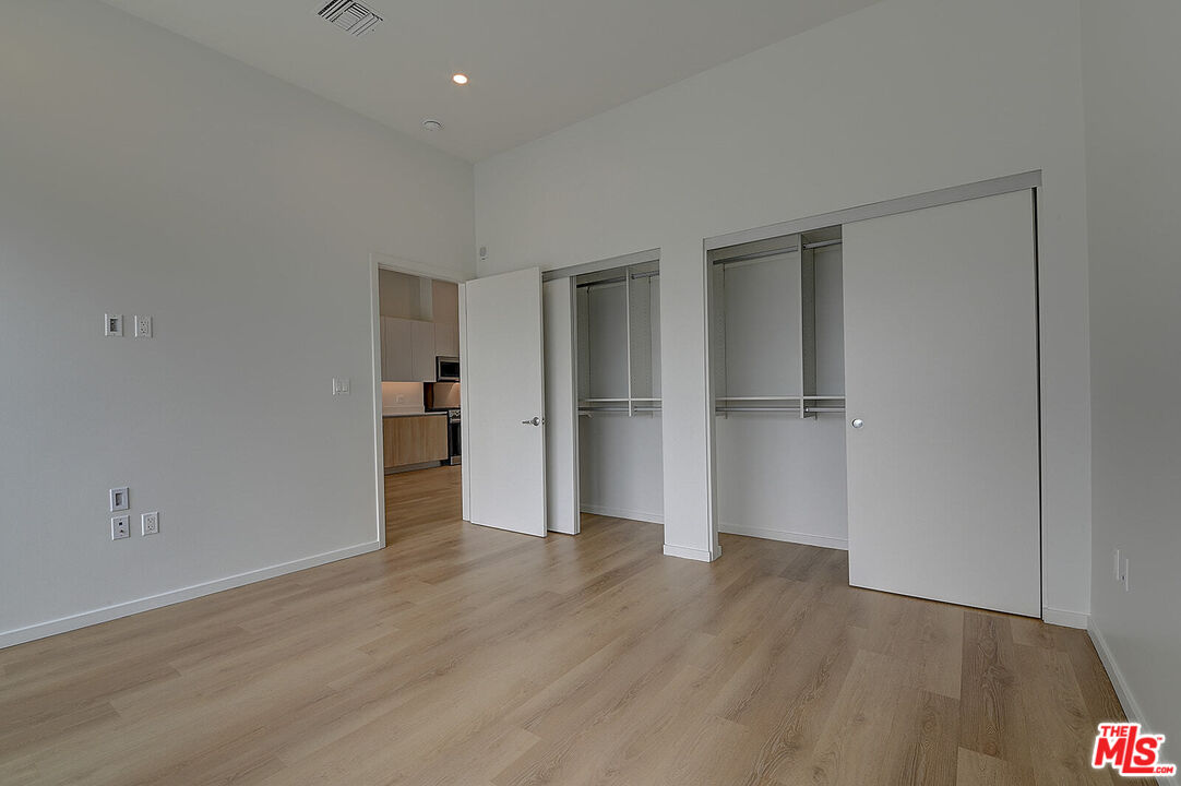 200 West Ocean Boulevard, Unit 711 Long Beach, CA 90802 - Photo 15 of 21 a view of an empty room with wooden floor and closet