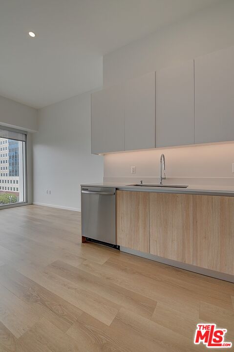 200 West Ocean Boulevard, Unit 711 Long Beach, CA 90802 - Photo 18 of 21 a kitchen with cabinets and a wooden floor
