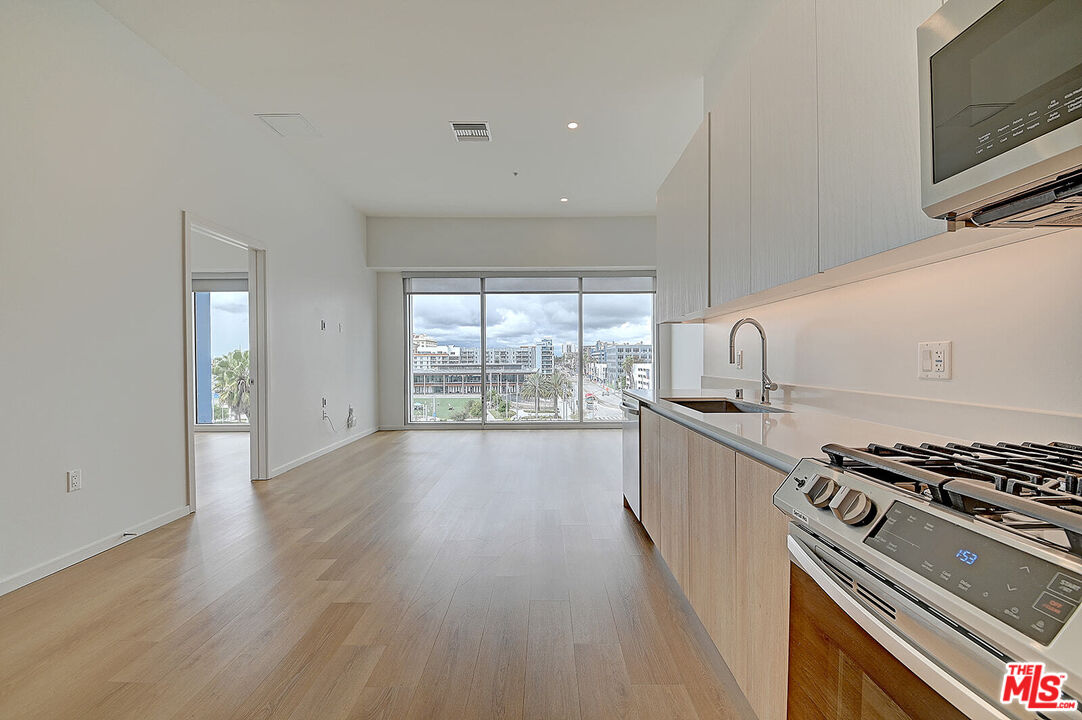 200 West Ocean Boulevard, Unit 711 Long Beach, CA 90802 - Photo 3 of 21 a kitchen with stainless steel appliances a stove top oven and sink