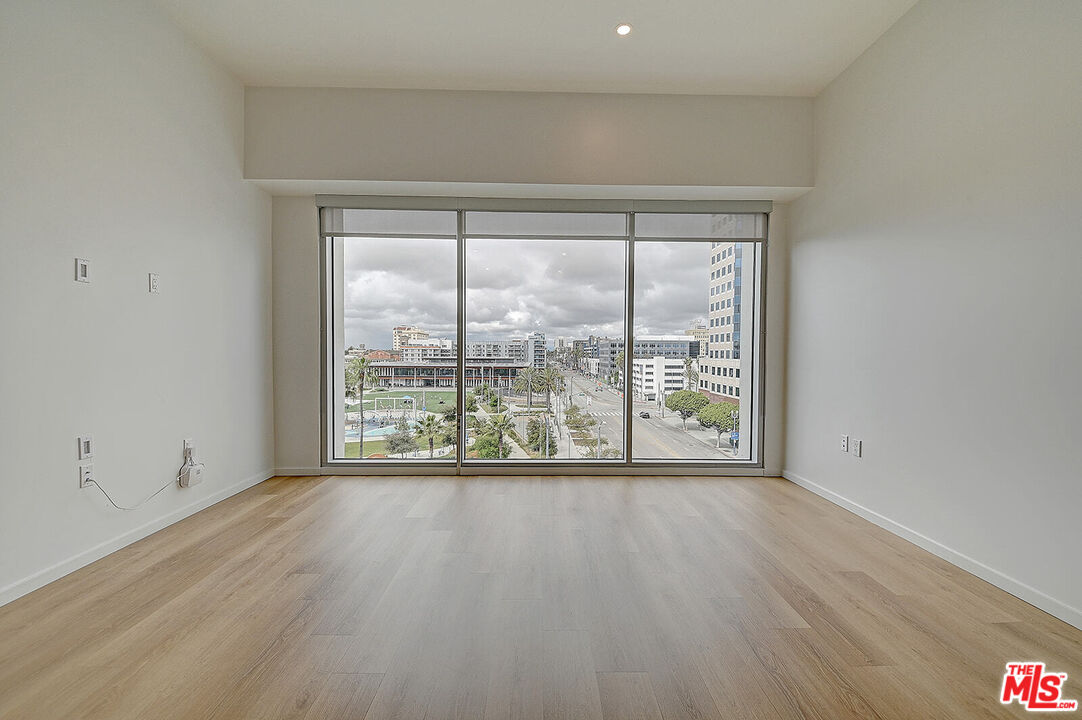 200 West Ocean Boulevard, Unit 711 Long Beach, CA 90802 - Photo 8 of 21 a view of an empty room with wooden floor and a window