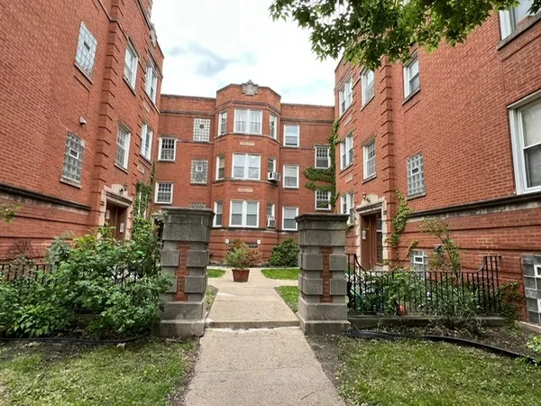 a front view of a residential apartment building with a yard