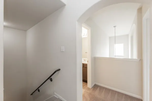 a view of a hallway with windows