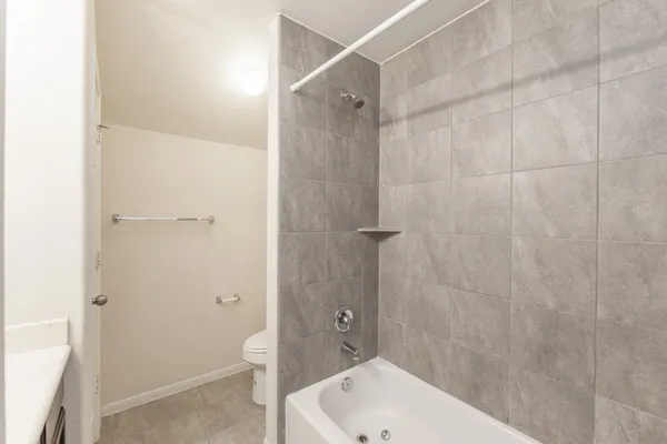 a bathroom with a bathtub and shower