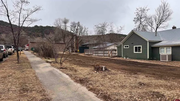 a view of a yard and front view of a house