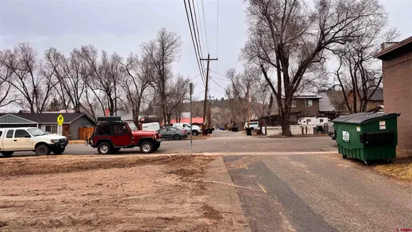 a view of street with parked cars