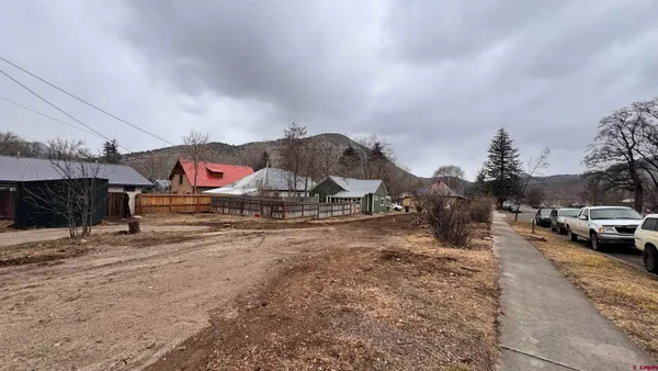 a view of a town with cars parked