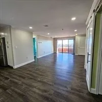an empty room with wooden floor and a window
