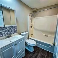 a spacious bathroom with a granite countertop sink and a mirror