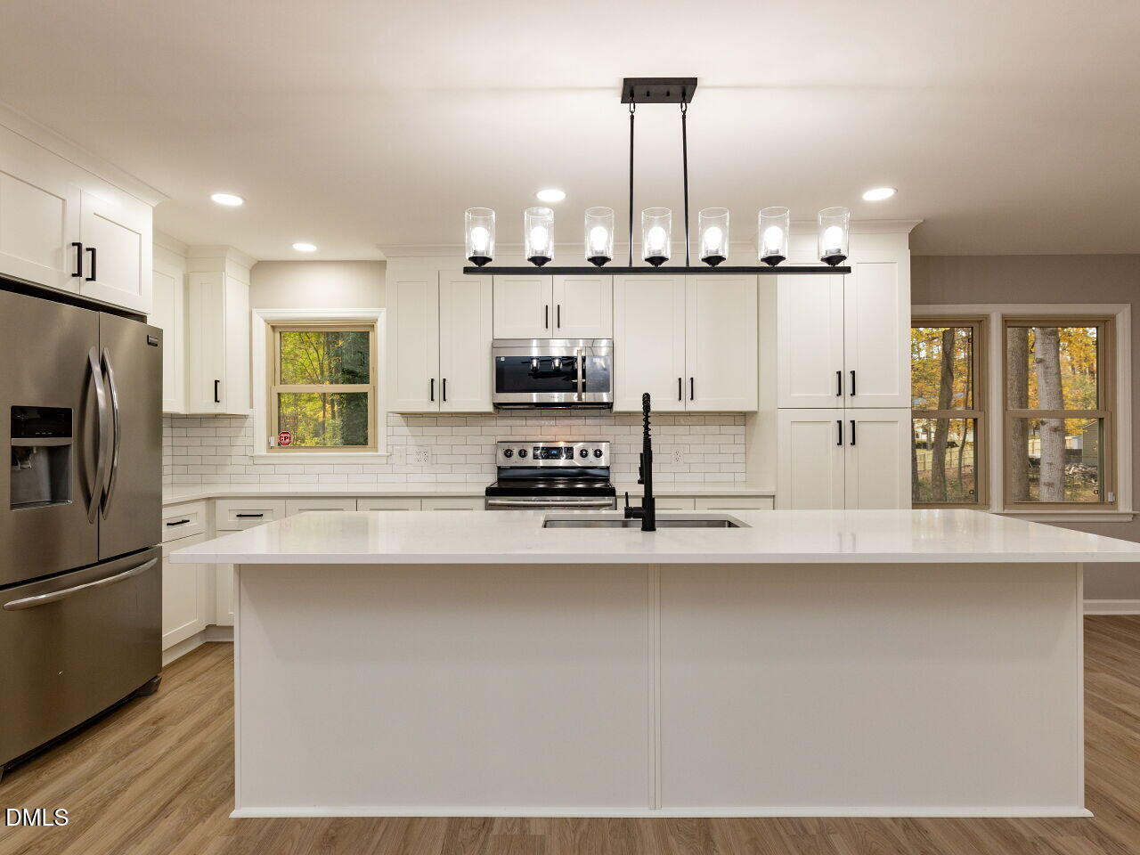 4800 Theys Road Raleigh, NC 27606 - Photo 12 of 43 a kitchen with stainless steel appliances a refrigerator a stove a sink and a oven