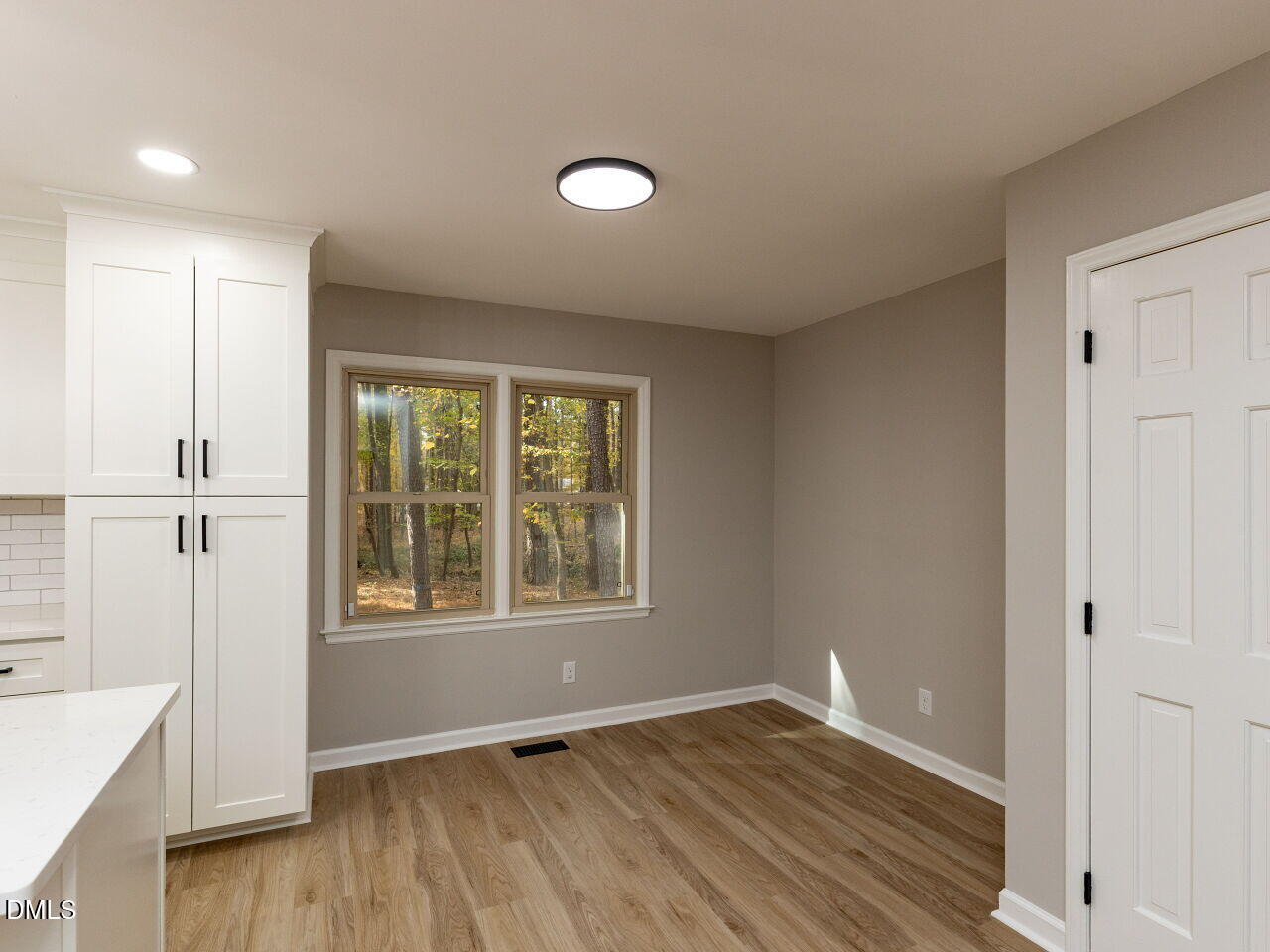 4800 Theys Road Raleigh, NC 27606 - Photo 14 of 43 an empty room with wooden floor and windows