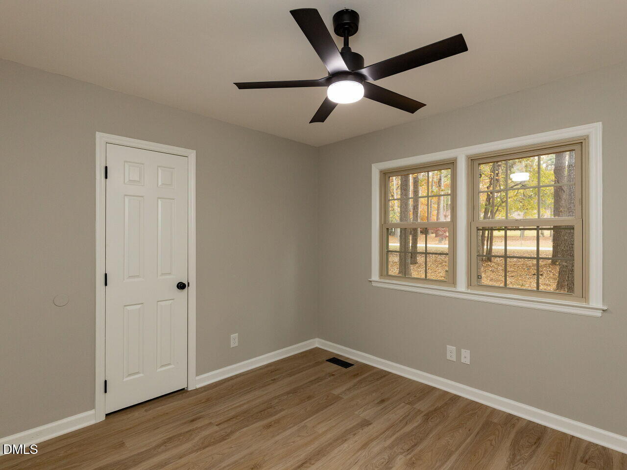 4800 Theys Road Raleigh, NC 27606 - Photo 15 of 43 a view of an empty room with wooden floor and a window