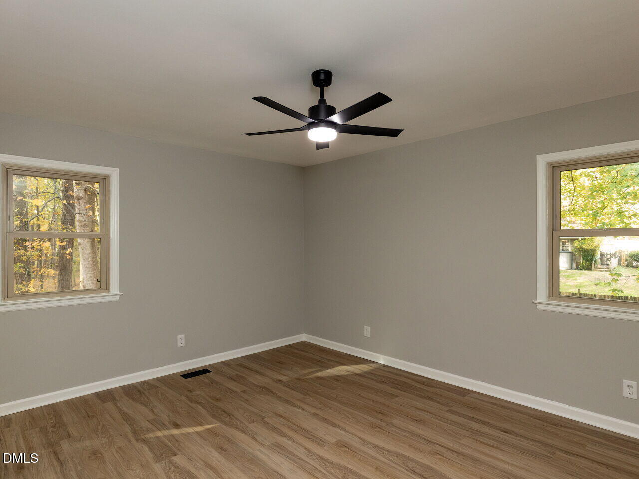 4800 Theys Road Raleigh, NC 27606 - Photo 18 of 43 an empty room with wooden floor and windows
