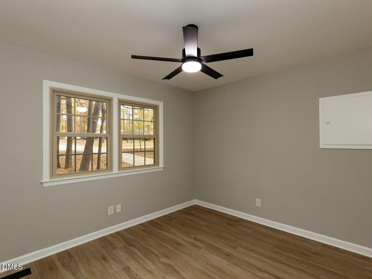 4800 Theys Road Raleigh, NC 27606 - Photo 22 of 43 a view of an empty room with wooden floor and a window