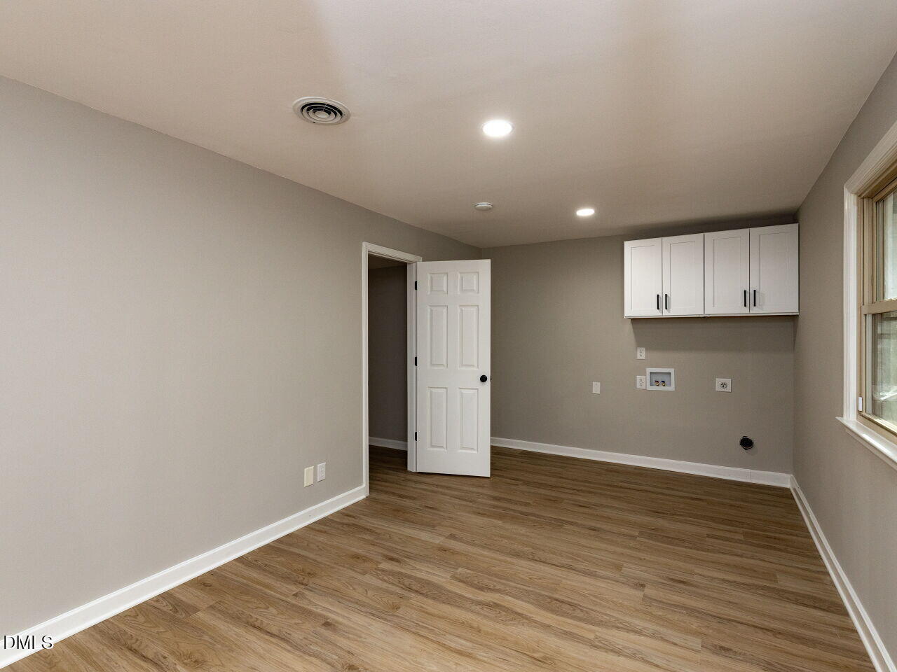 4800 Theys Road Raleigh, NC 27606 - Photo 25 of 43 a view of an empty room with wooden floor and a window