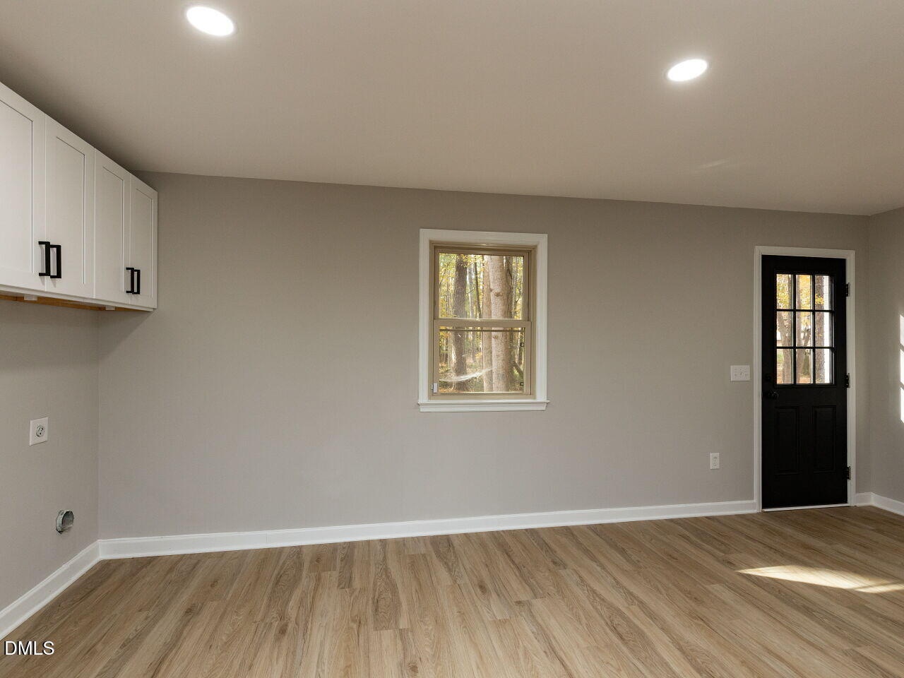 4800 Theys Road Raleigh, NC 27606 - Photo 26 of 43 a view of an empty room with wooden floor and a window