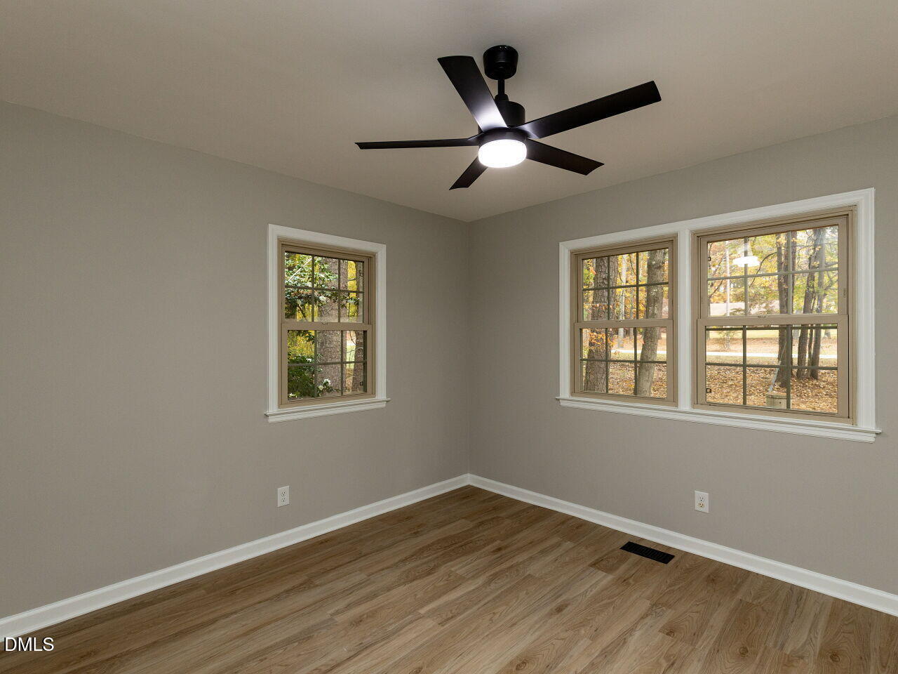 4800 Theys Road Raleigh, NC 27606 - Photo 29 of 43 a view of an empty room with wooden floor and a window