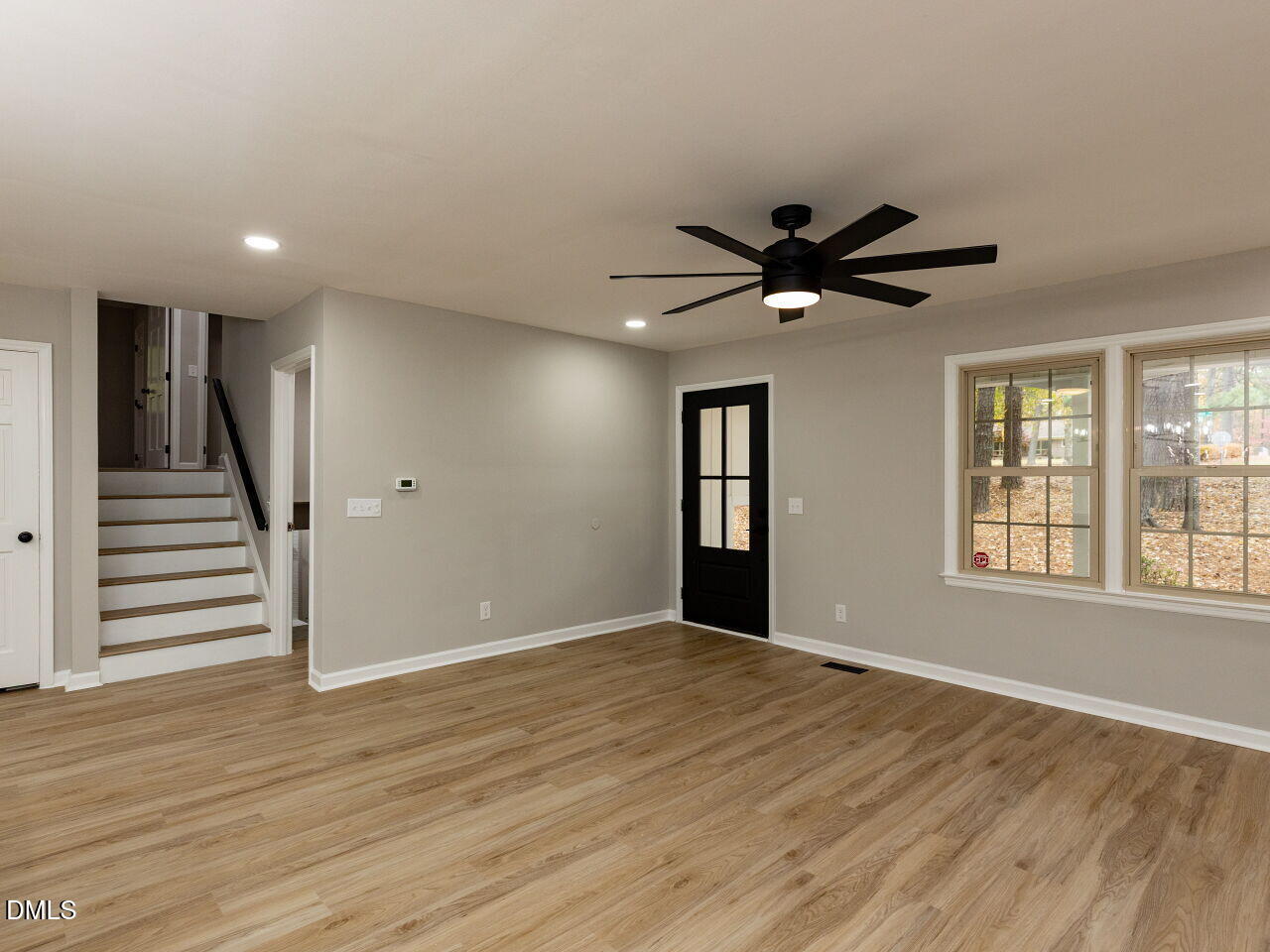 4800 Theys Road Raleigh, NC 27606 - Photo 10 of 43 a view of an empty room with wooden floor and a window