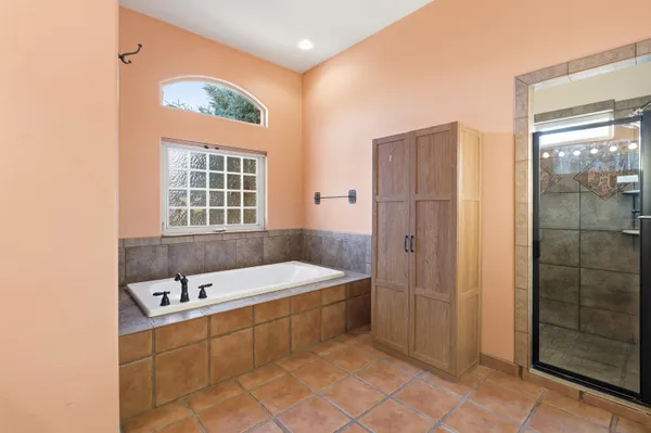 a bathroom with a tub a sink and a shower