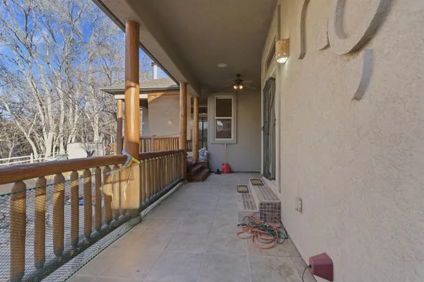 a view of a porch with wooden floor and stairs