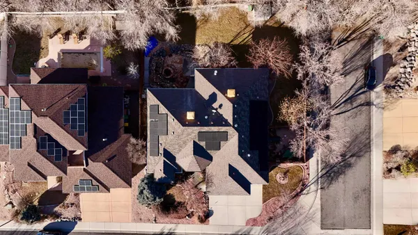 an aerial view of a house with a yard