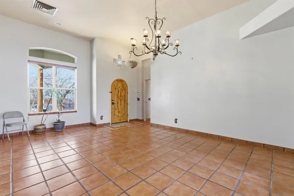 a view of a room with window and chandelier