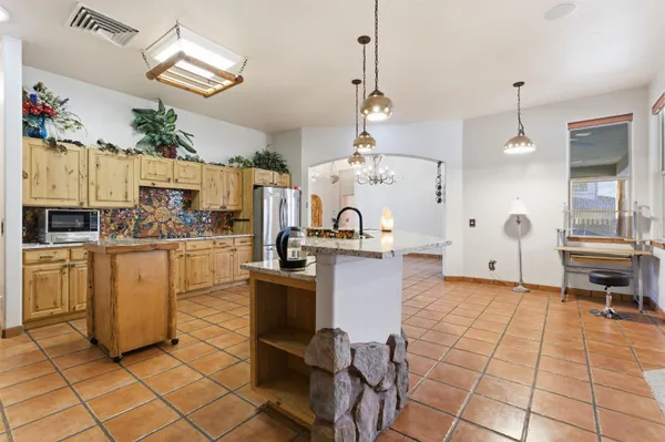 a kitchen with cabinets and chairs