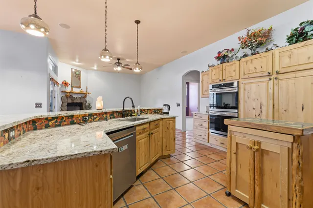 a kitchen with stainless steel appliances granite countertop a sink and cabinets