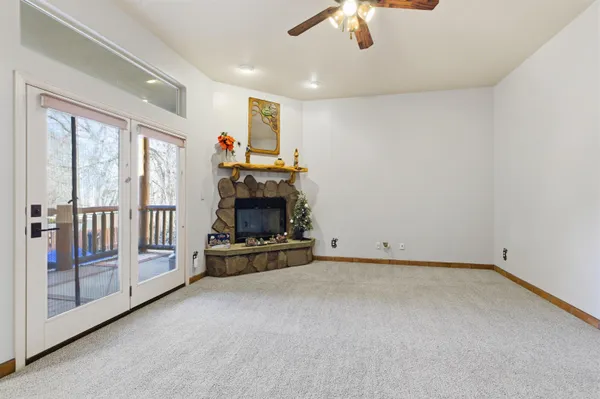 an empty room with furniture fire place and windows