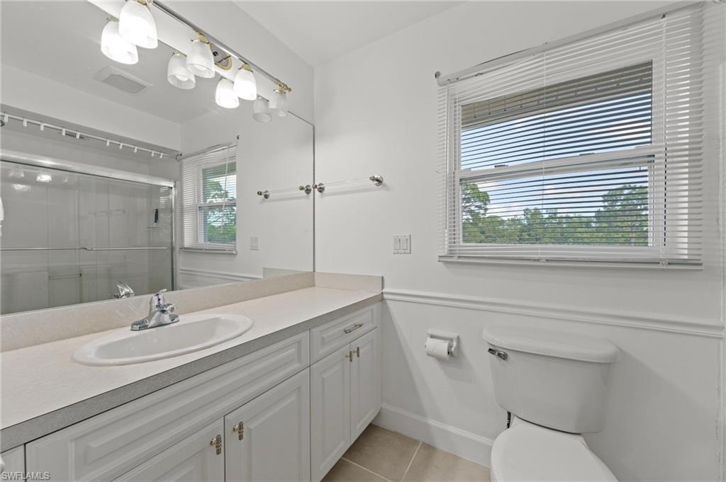 13541 Stringfellow Road Bokeelia, FL 33922 - Photo 20 of 49 a bathroom with a sink a toilet and a mirror
