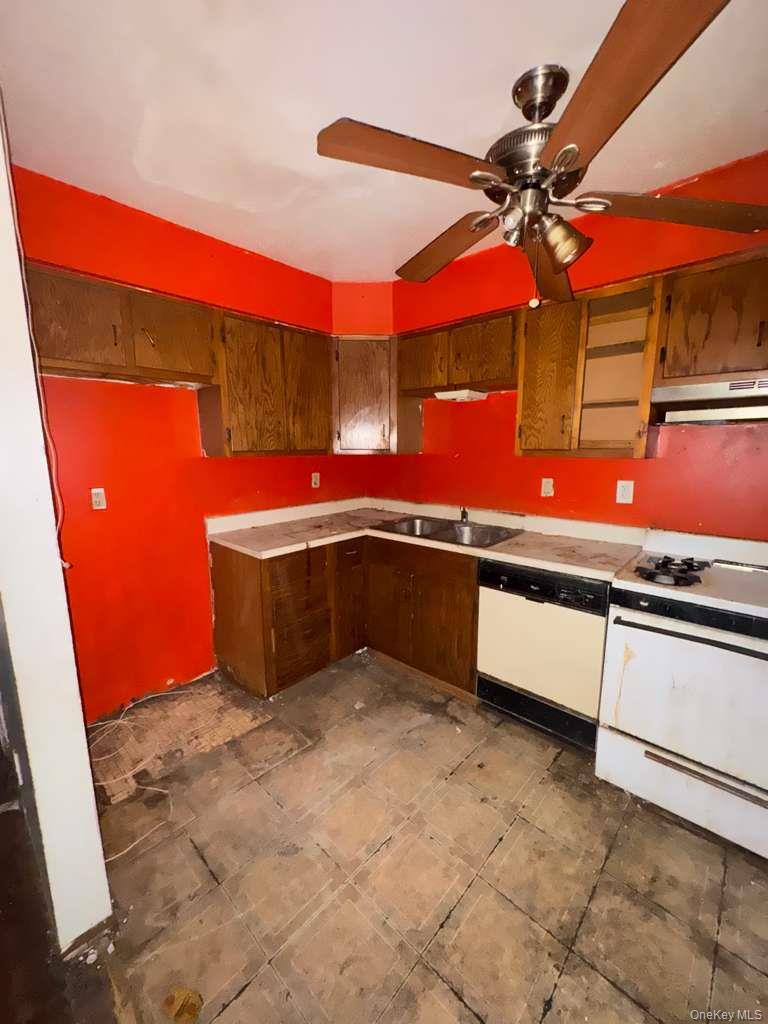 2028 Story Avenue Bronx, NY 10473 - Photo 13 of 16 Kitchen featuring white appliances, light countertops, under cabinet range hood, and ceiling fan