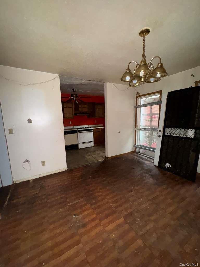 2028 Story Avenue Bronx, NY 10473 - Photo 14 of 16 Unfurnished dining area featuring a chandelier and ceiling fan