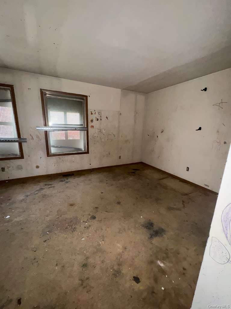 2028 Story Avenue Bronx, NY 10473 - Photo 3 of 16 Spare room featuring concrete floors and baseboards