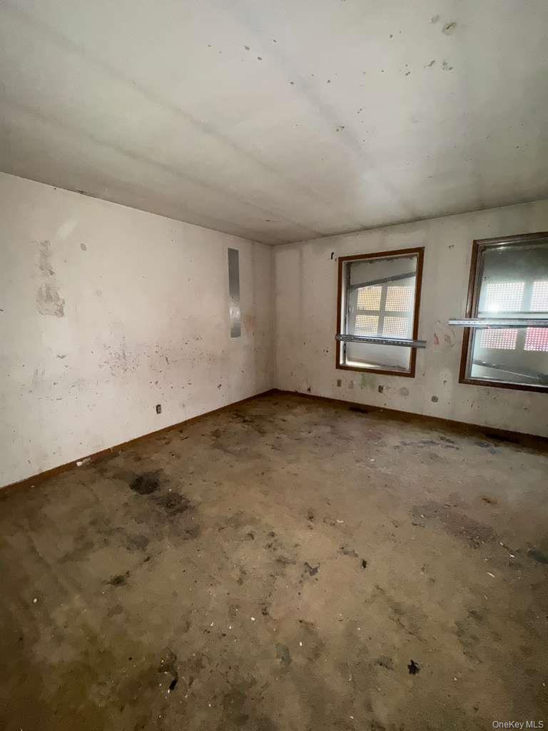 2028 Story Avenue Bronx, NY 10473 - Photo 4 of 16 Empty room with unfinished concrete flooring and cooling unit