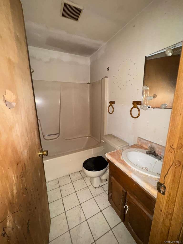 2028 Story Avenue Bronx, NY 10473 - Photo 5 of 16 Bathroom with vanity, light tile patterned floors, and shower / tub combination