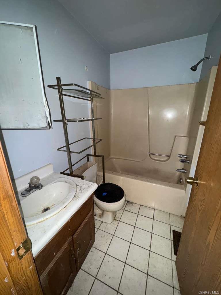 2028 Story Avenue Bronx, NY 10473 - Photo 9 of 16 Full bathroom with vanity, light tile patterned flooring, and bathing tub / shower combination