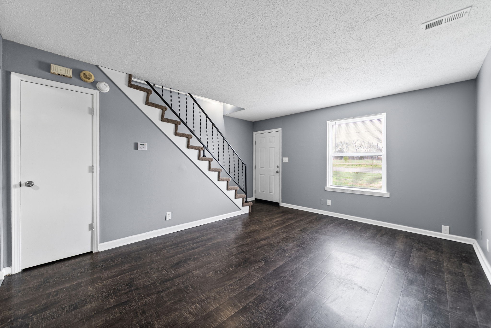 1269 State Line Road, Unit 40 Oak Grove, KY 42262 - Photo 4 of 16 a view of an empty room with wooden floor and stairs