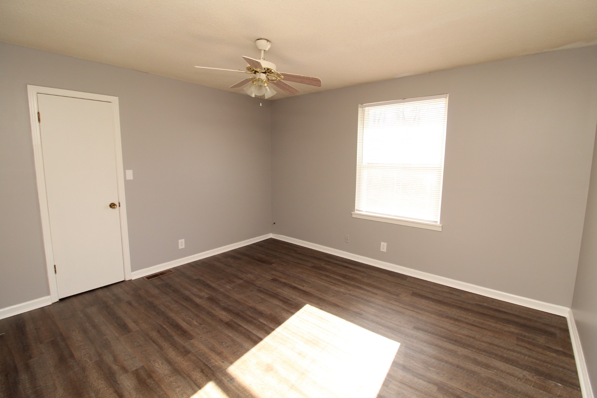 1269 State Line Road, Unit 40 Oak Grove, KY 42262 - Photo 4 of 6 a view of an empty room with wooden floor and a window