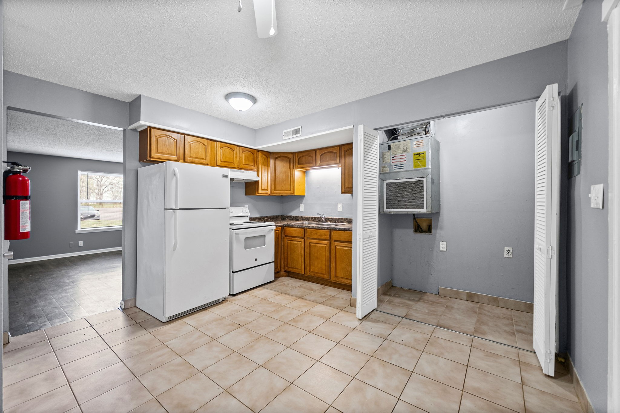 1269 State Line Road, Unit 40 Oak Grove, KY 42262 - Photo 5 of 16 a kitchen with a refrigerator a stove top oven and cabinets