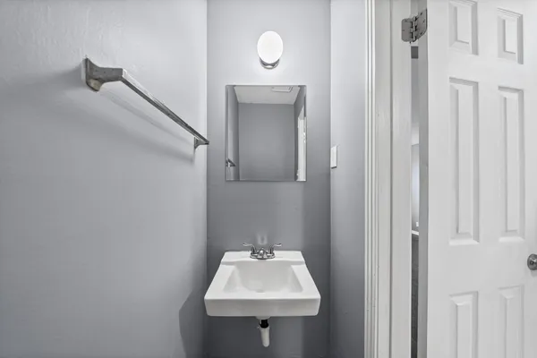 a bathroom with a sink a mirror and vanity