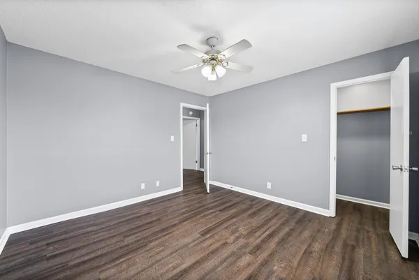 a view of an empty room with wooden floor